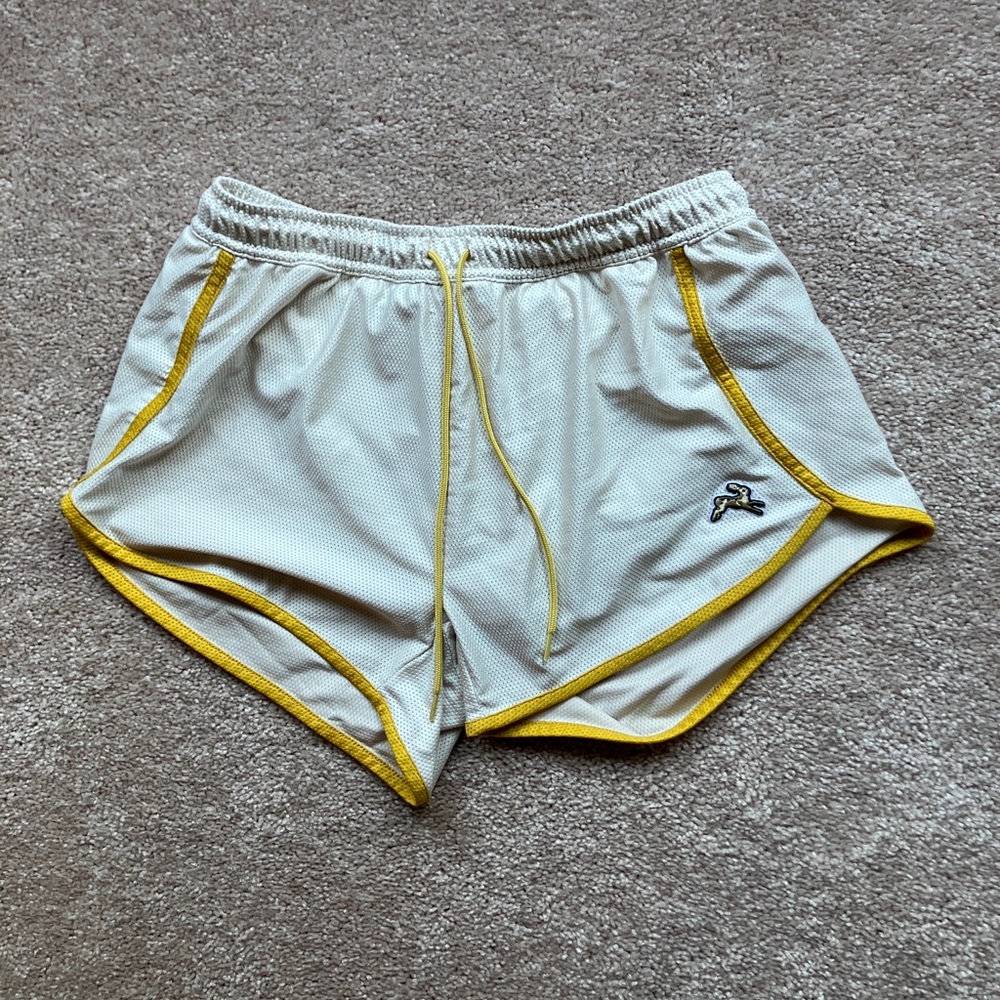 Tracksmith white van cortlandt shorts with yellow trim